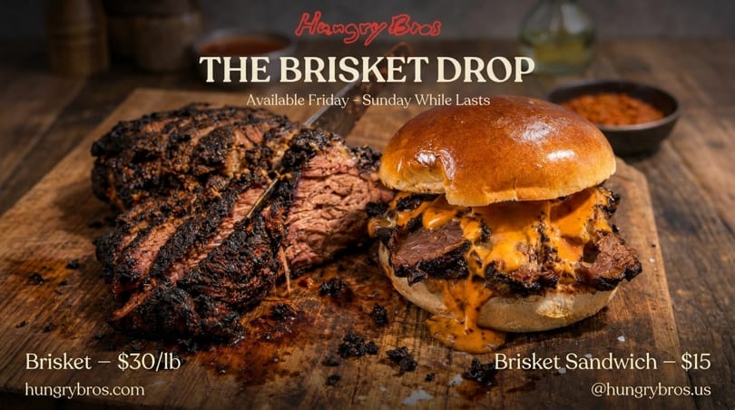 A large, smoked brisket is sliced on a wooden board next to a brisket sandwich with melted cheese.